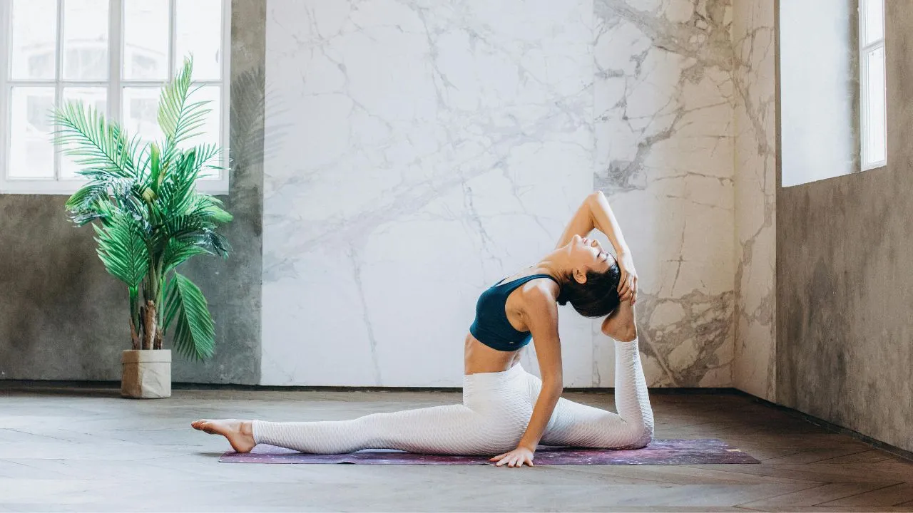 Person practicing Embodied Yoga with mindful breathing and gentle movement in a peaceful studio
