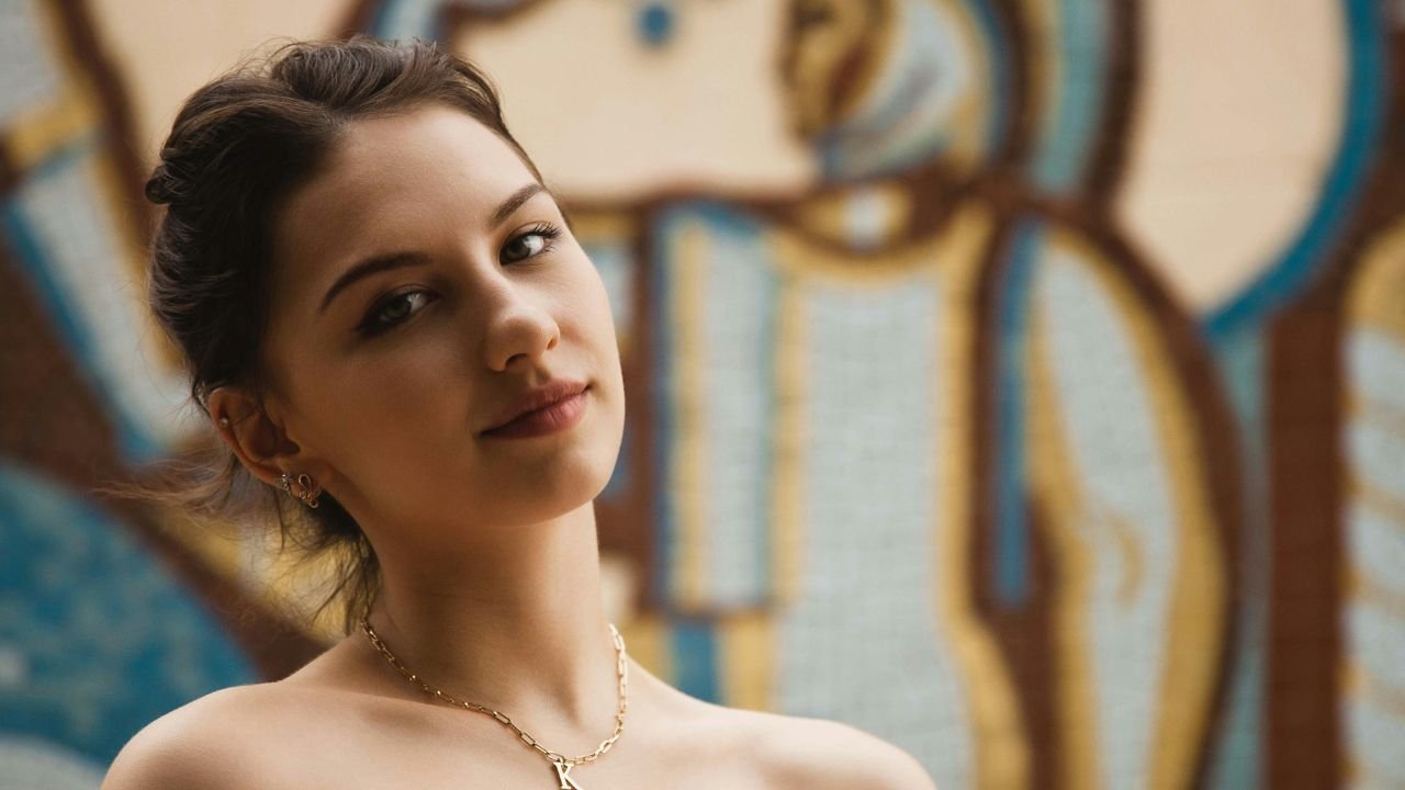 A person sitting calmly in nature with a journal, reflecting deeply, symbolizing the practice of mindful inquiry.